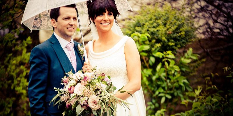 bride and groom with umbrella