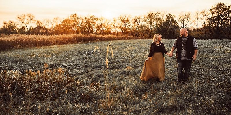 bride and groom in a field