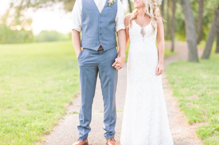 bride and groom holding hands