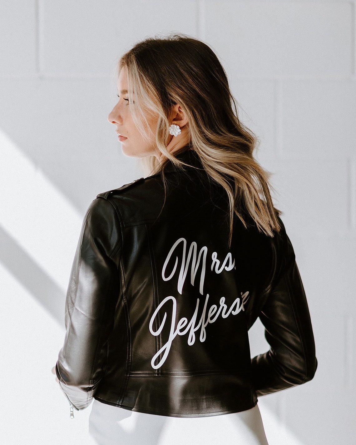 This image shows a woman wearing a customised leather jacket. 