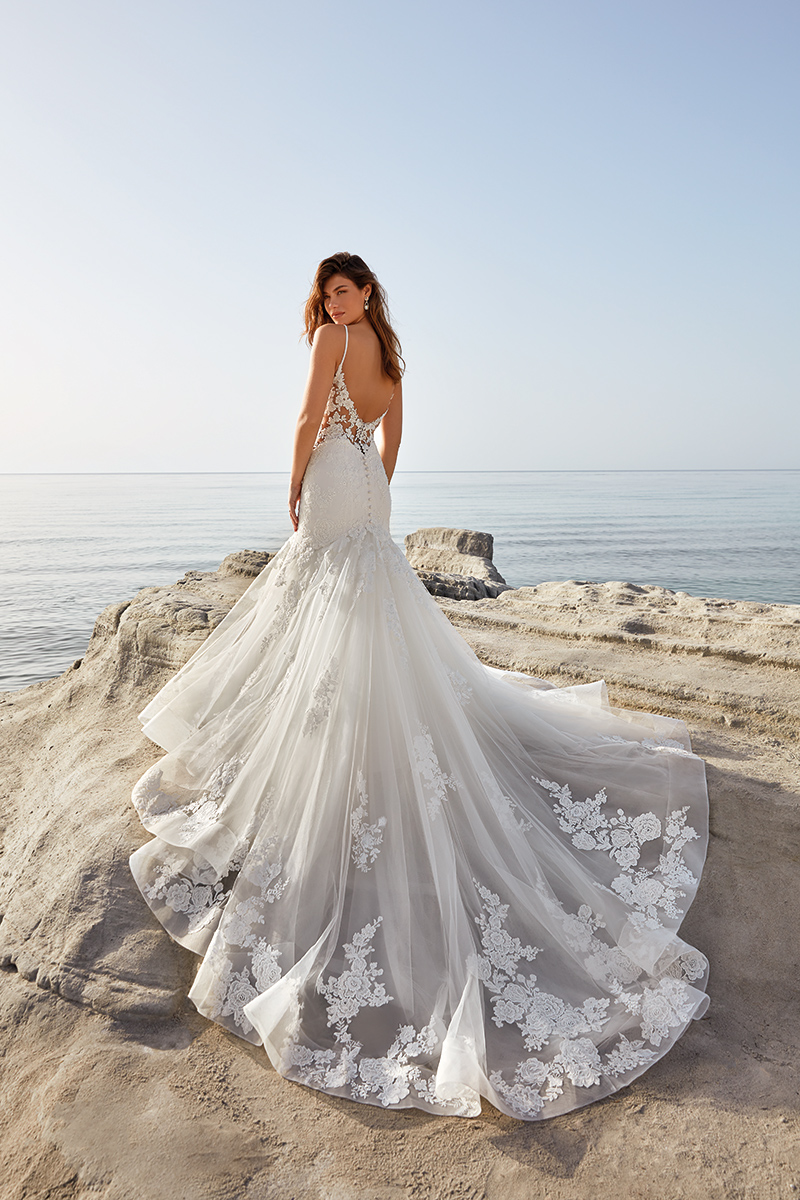 This image shows the Demi dress by Eddy K which showcases wedding dress trends such as dramatic trains