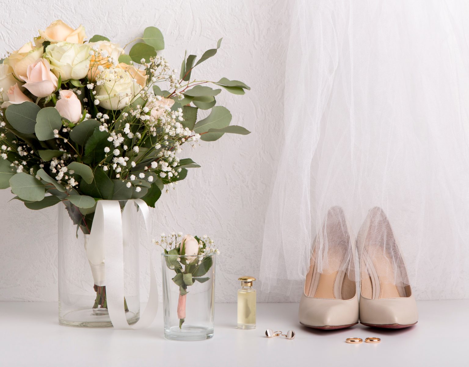 This image contains bridal flowers, shoes, perfume and jewellery. Feature image for Bridal Accessories