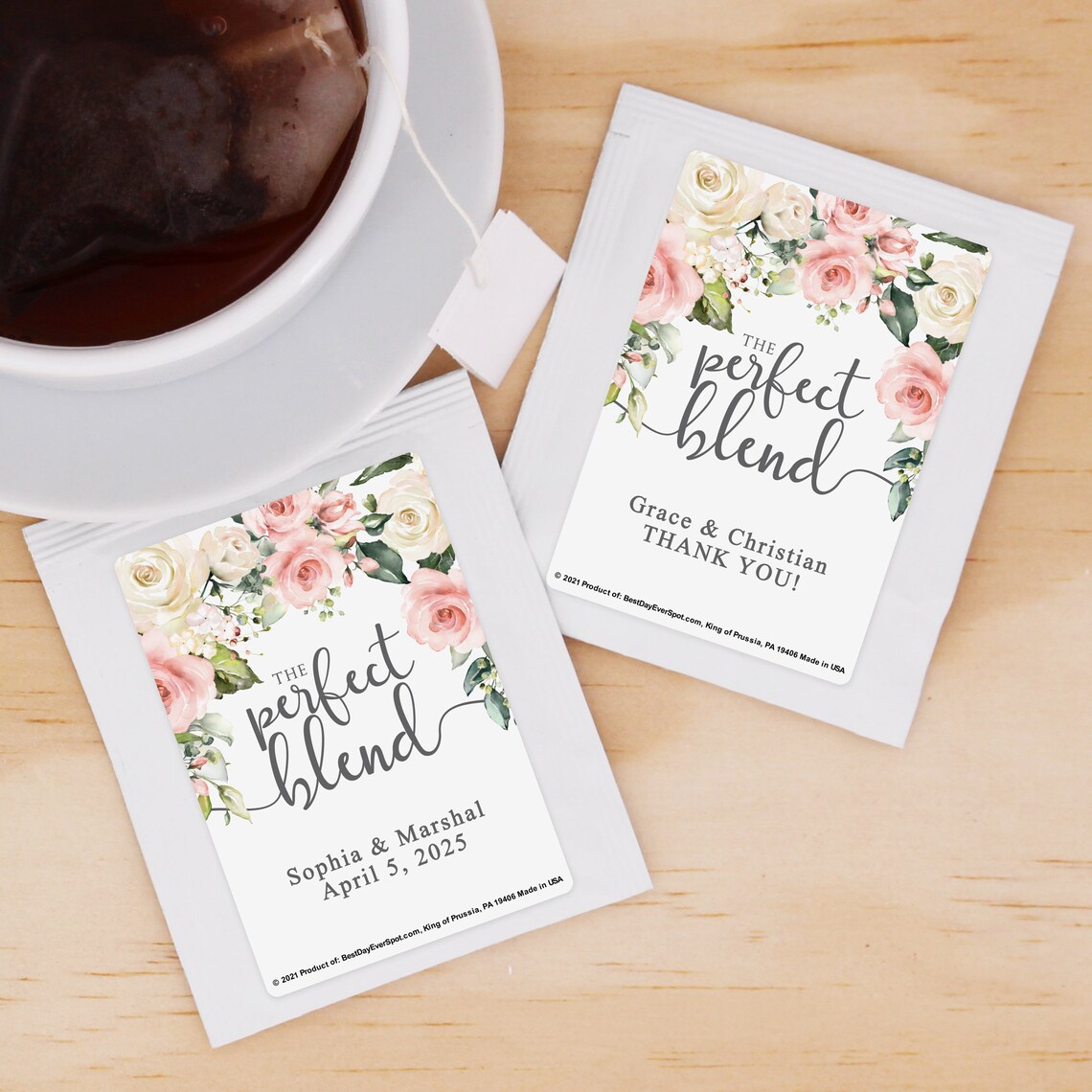 Two personalised teabag sachets showcasing the name of the couple sit beside a cup of tea. Image used in the Cute Wedding Favours Your Guests Will Want To Take Home article.