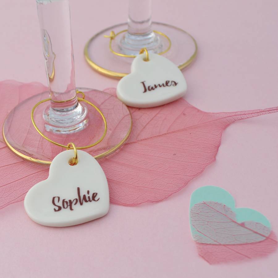Two glass charms rest at the bottom of a wine glass.