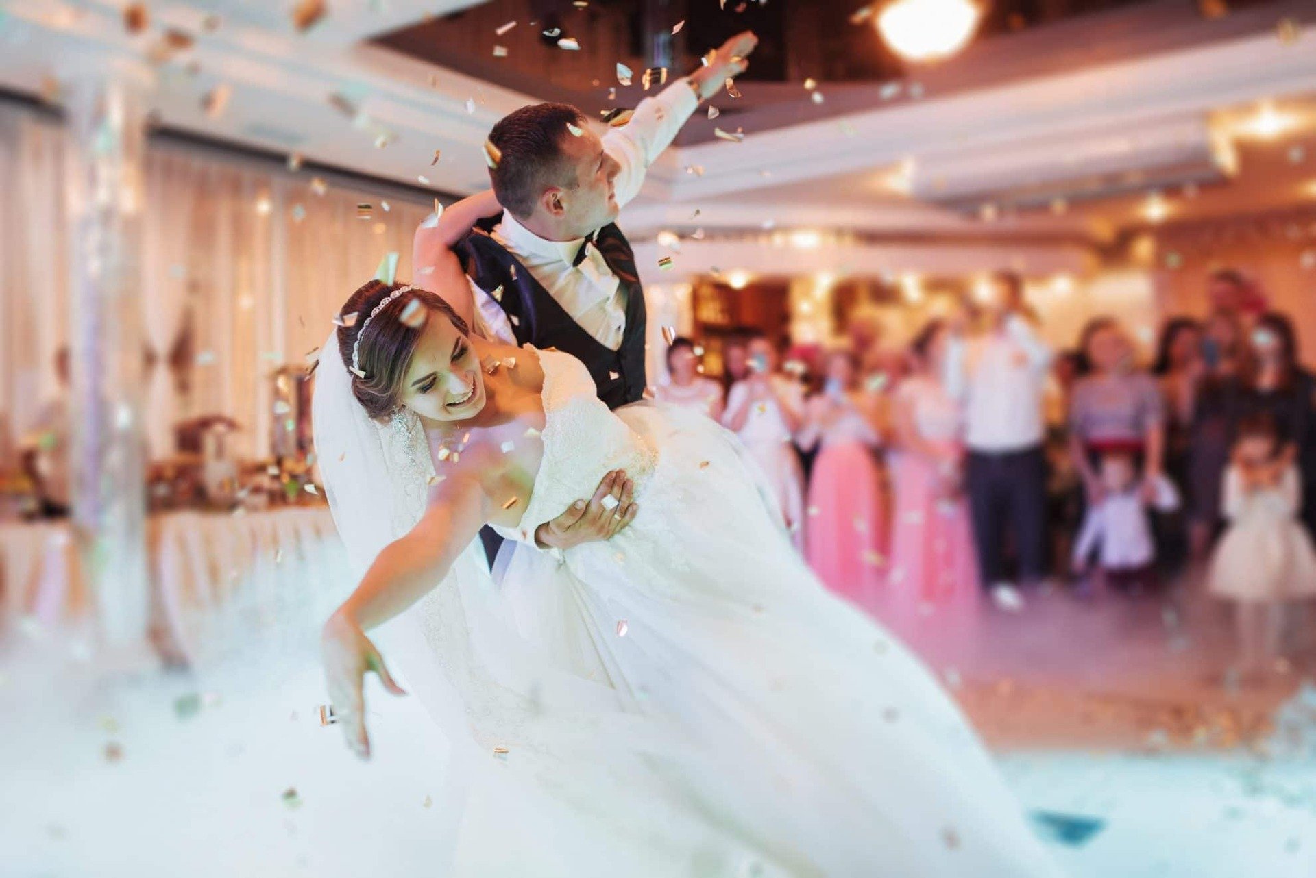 Bride and groom during their first dance as their guests watch on.