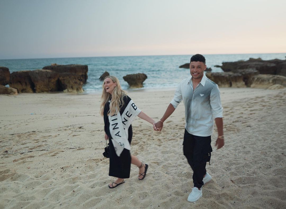 Perrie Edwards and Alex Oxlade-Chamberlain walking on the beach