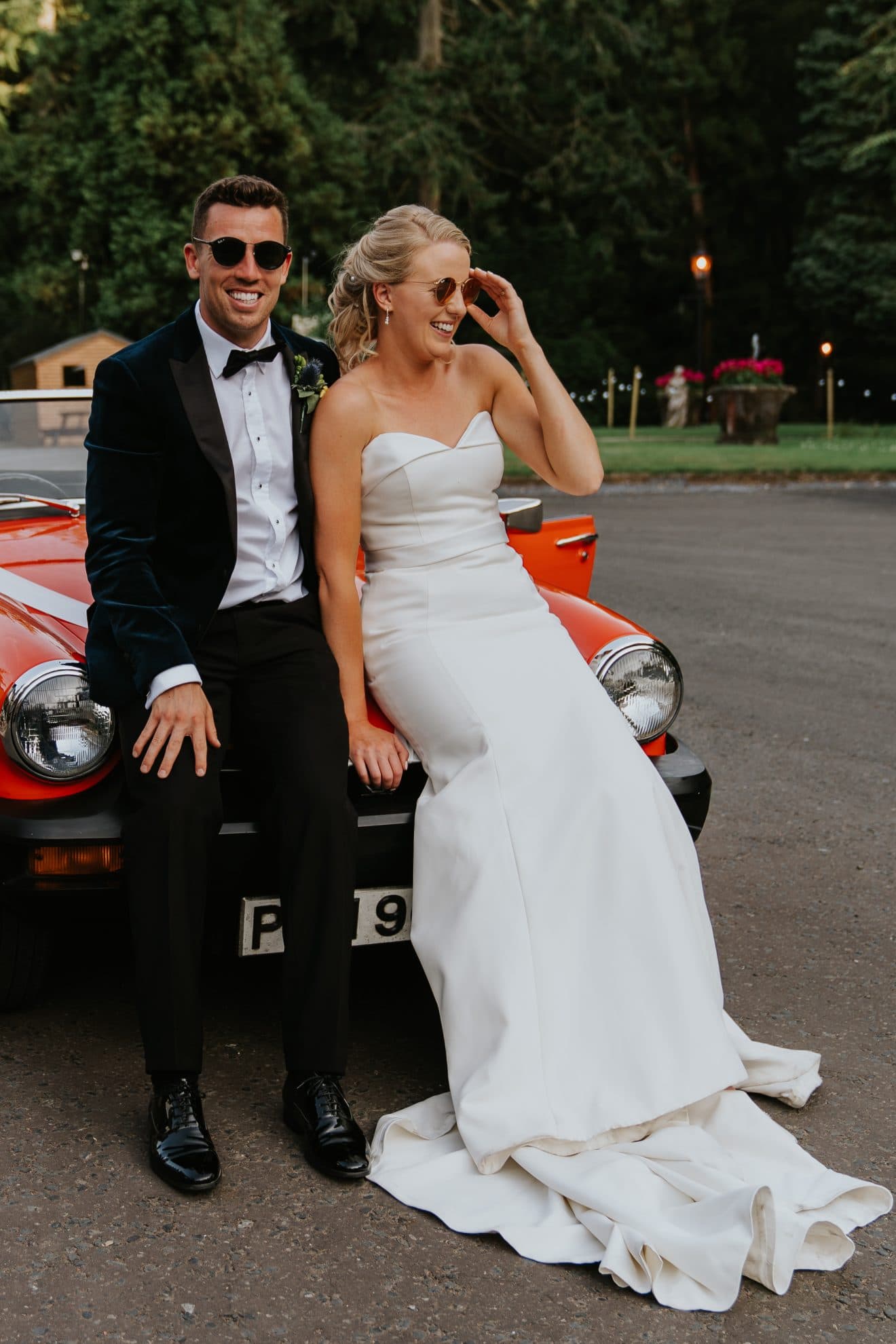 wedding at magheramorne estate - bride and groom with MG car