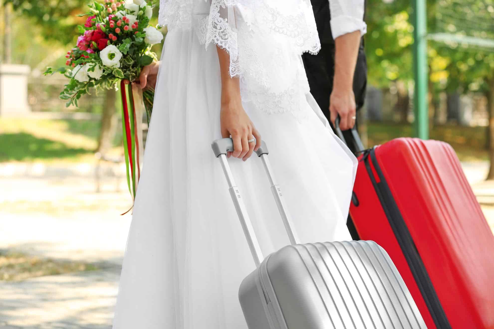 What To Include In Your Wedding Overnight Bag - couple with suitcases