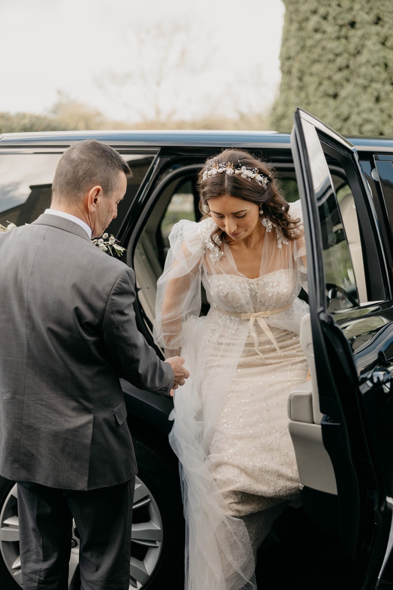 Joanne getting out of the wedding car to go inot the church