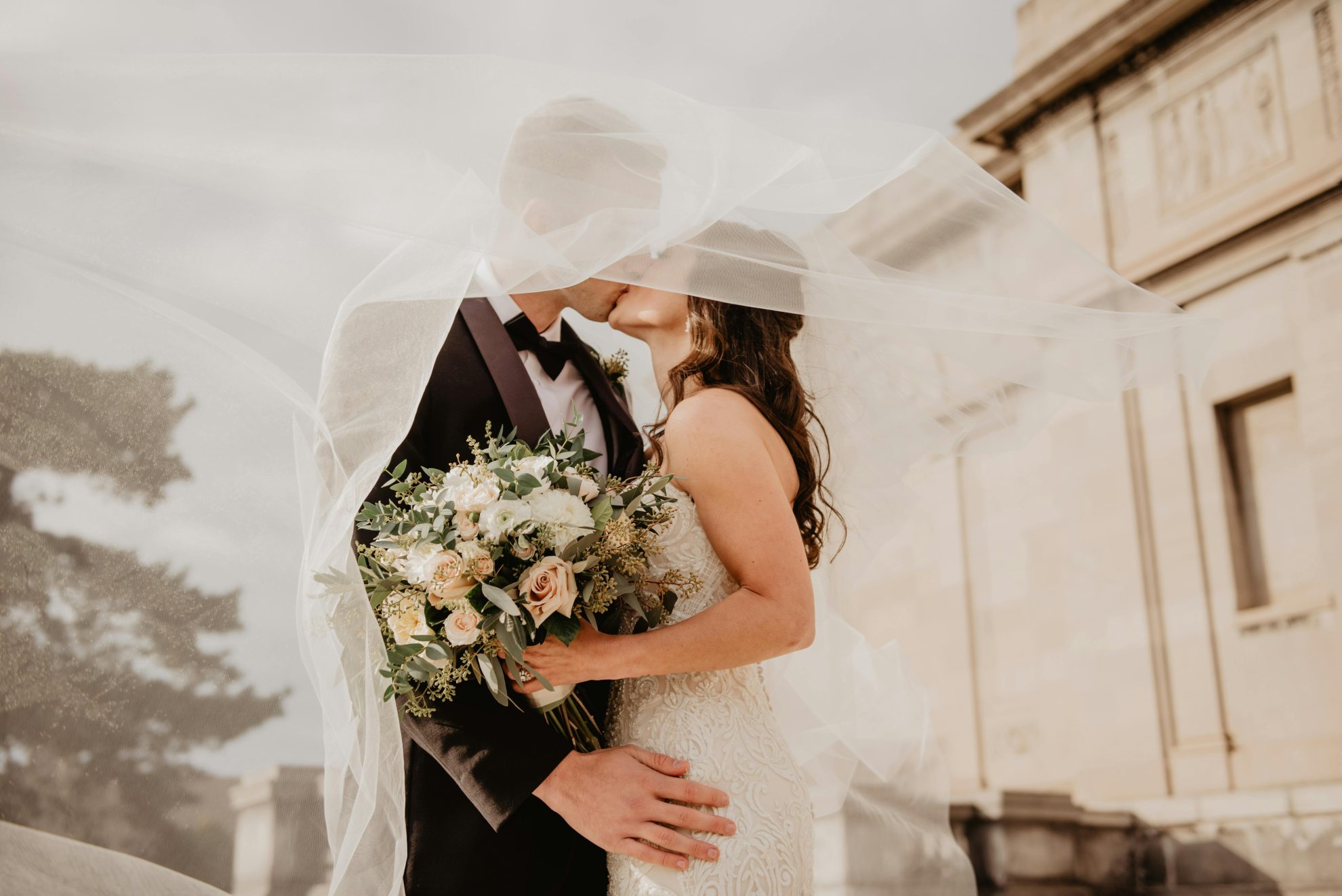 50 Essential Wedding Questions - couple having their wedding kiss