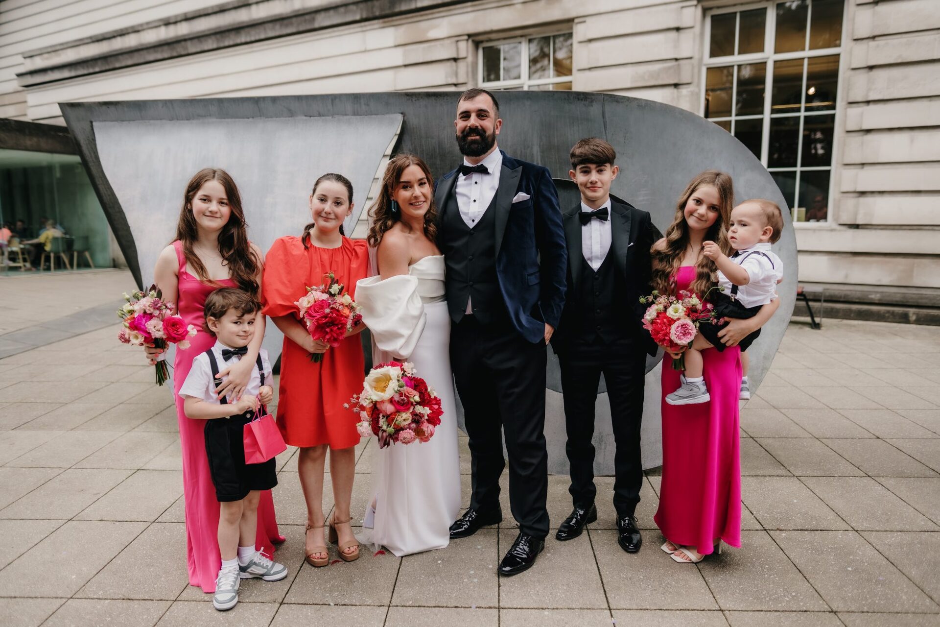 Jael and greg with hteir family on their wedding day