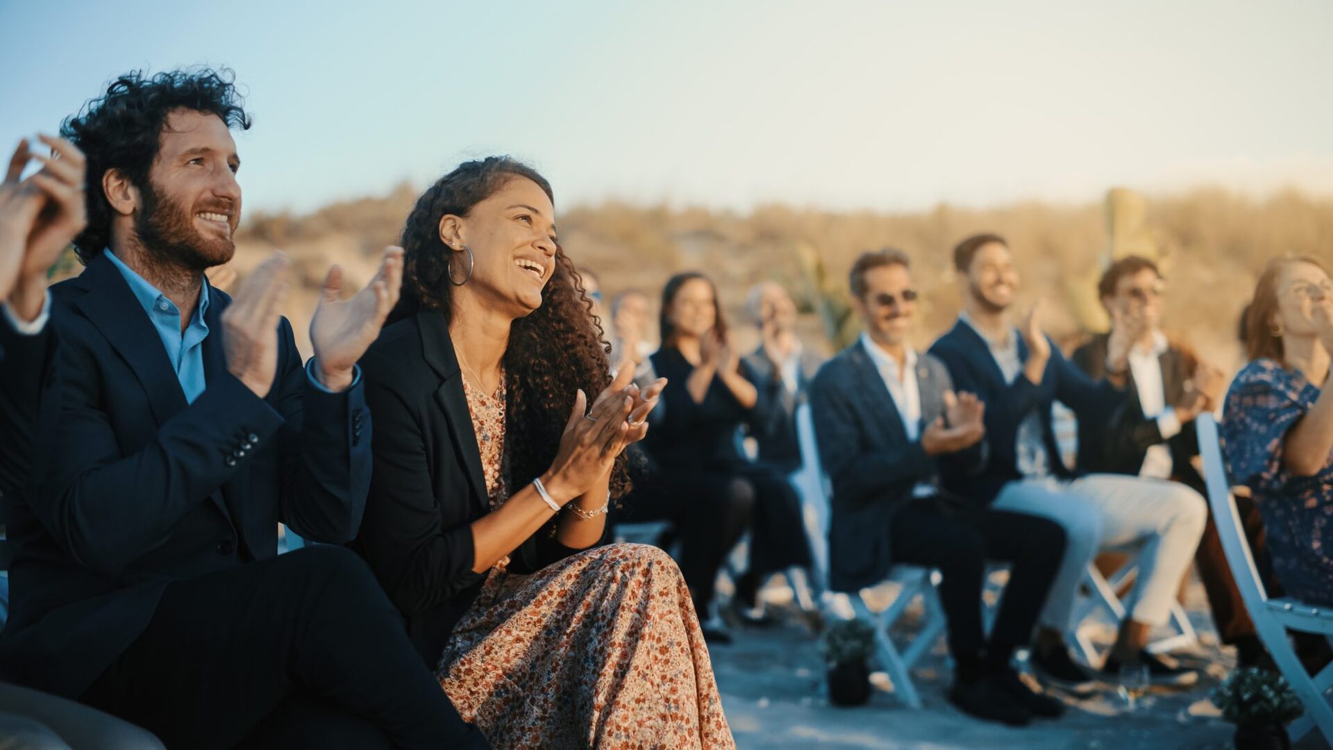 Guests applauding newlywed couple at their wedding ceremony