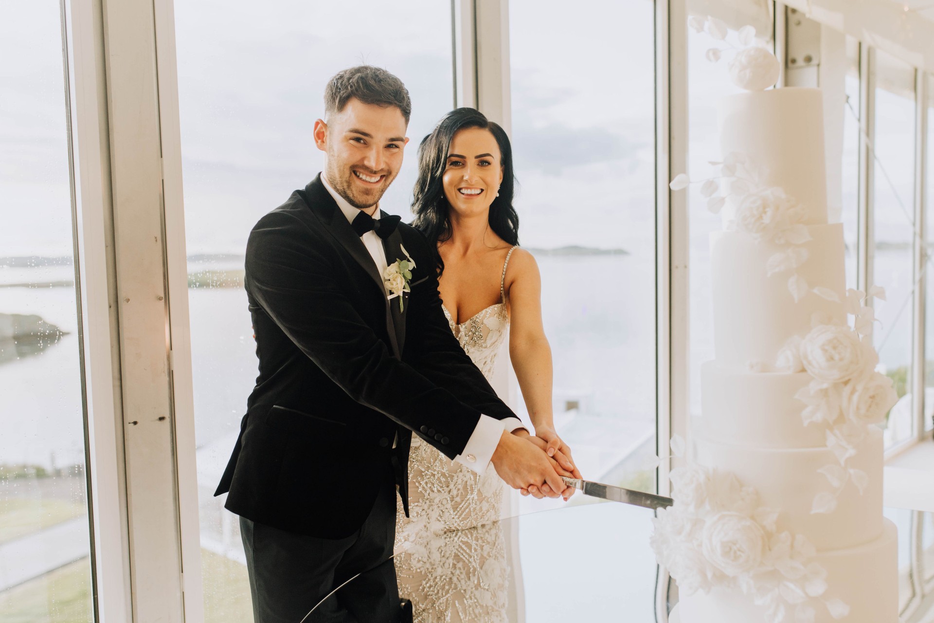 a couple cutting their wedding cake