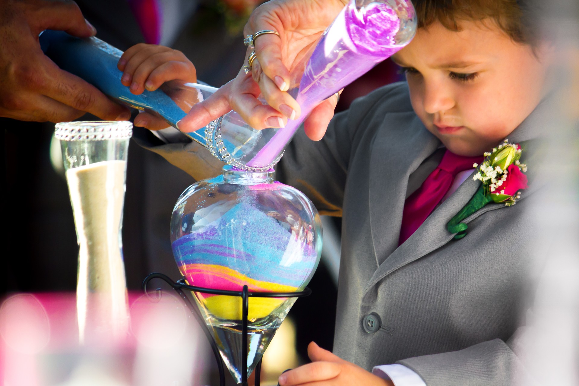 Children taking part in sand pouring at wedding ceremony